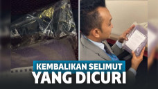 Bungkusan plastik berisi selimut dan surat