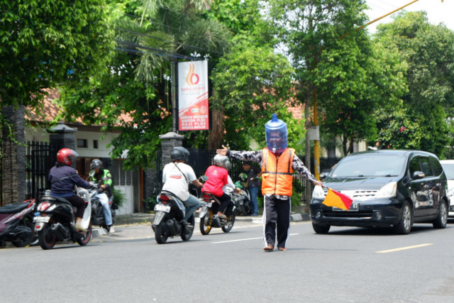 pengatur lalin pakai helm galon air